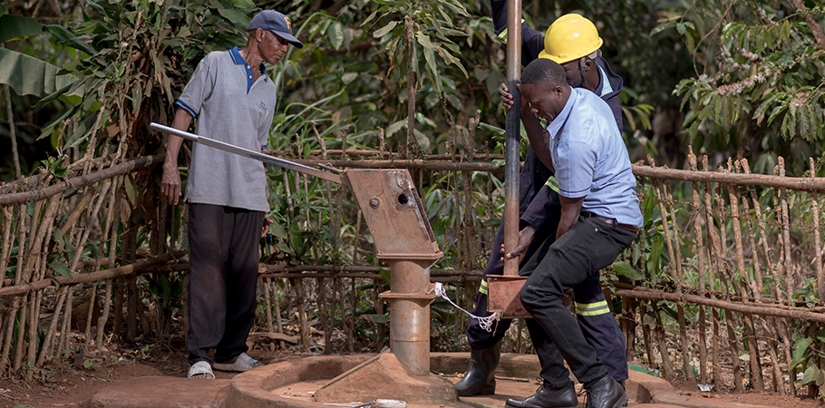 Mr. Niyonteze Sepiriyano, a resident of Ssenda Kakindu in Mityana district observes technicians from Whave Solutions as they carry out repairs on a borehole.