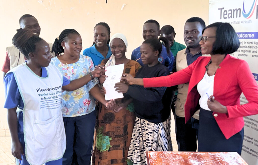 Youth handing over their issue paper to the Subcounty Chief of Namungo Subcounty (right), Mityana District
