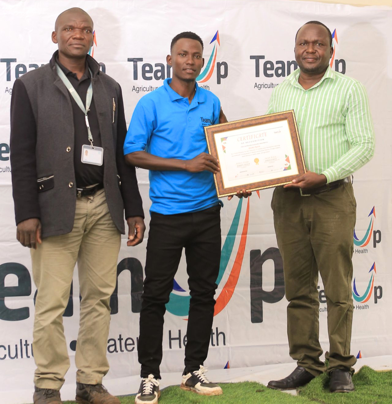 Syrus receiving a certificate of recognition for his work as a Youth Champion